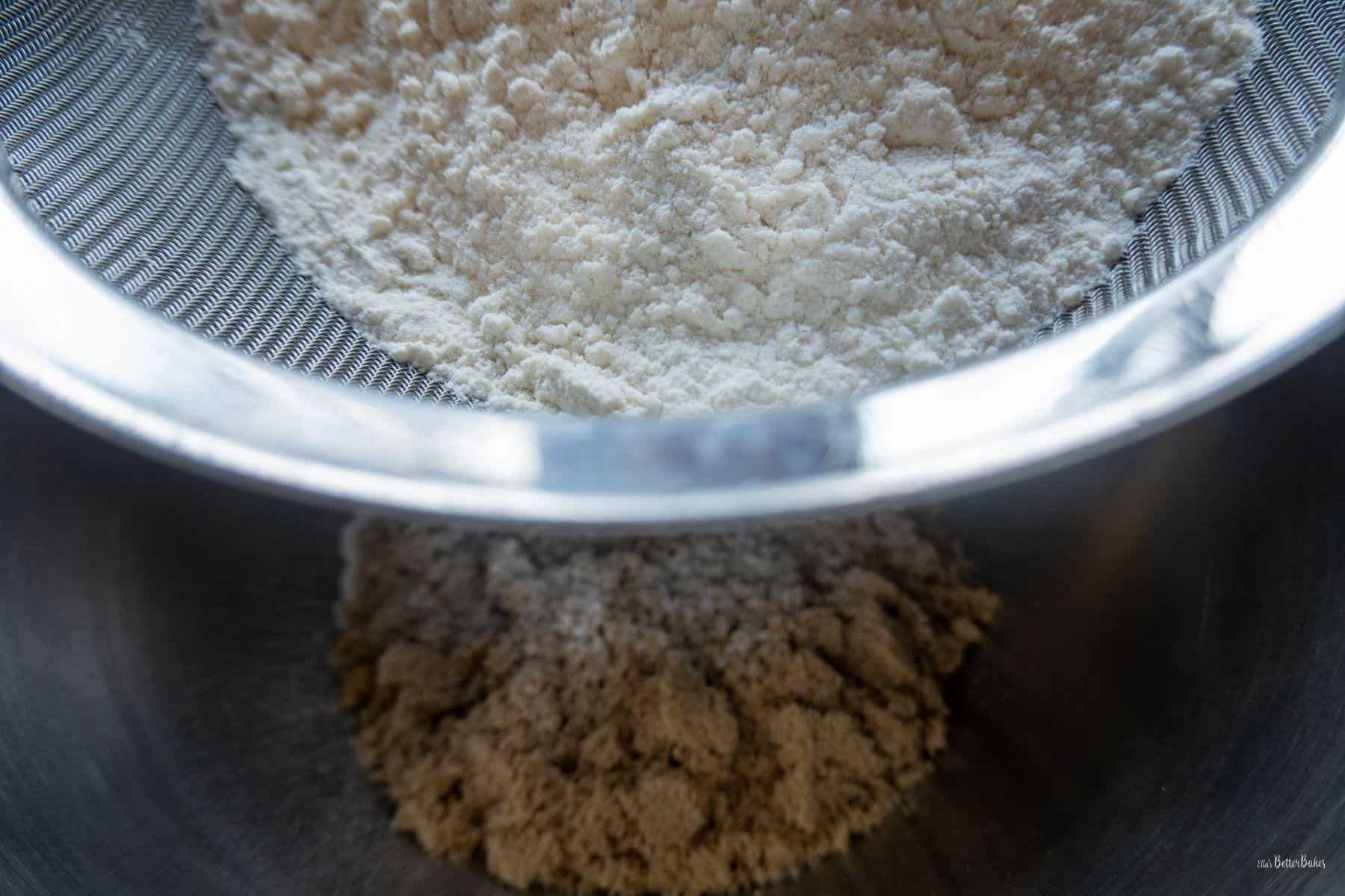 flour being sifted over brown sugars