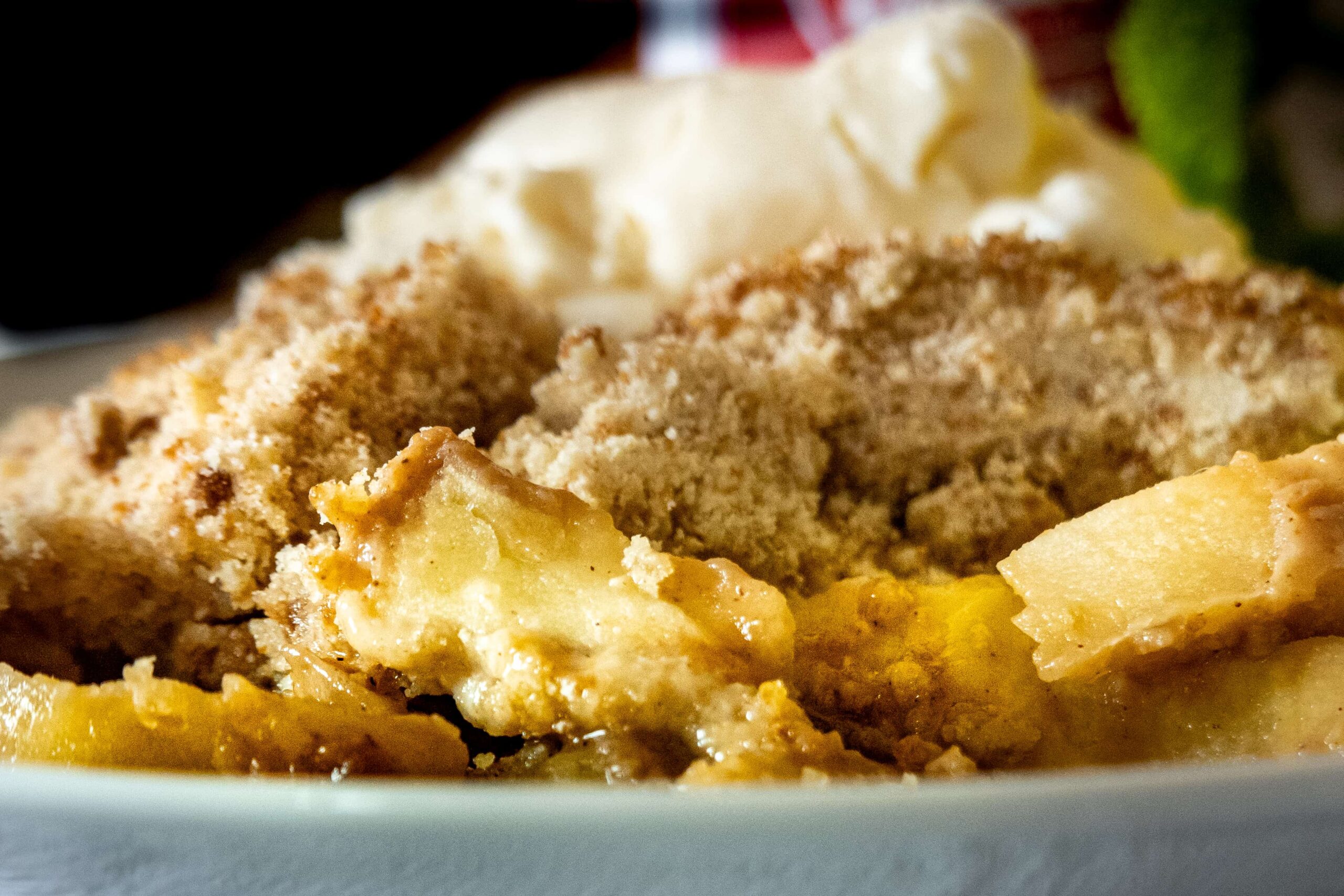 close up a dish of crumble and icecream