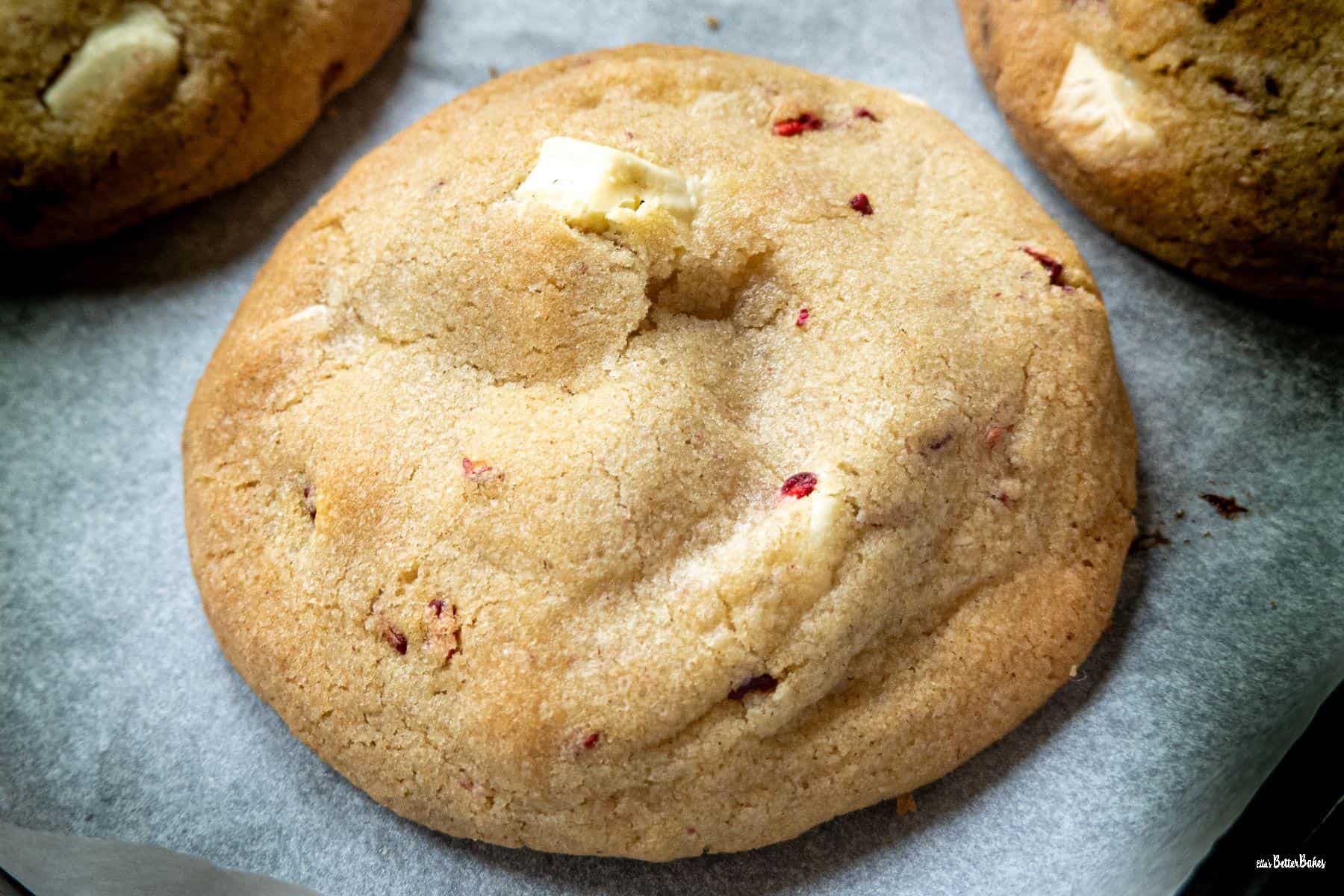 close up of a raspberry and white chocolate cookie