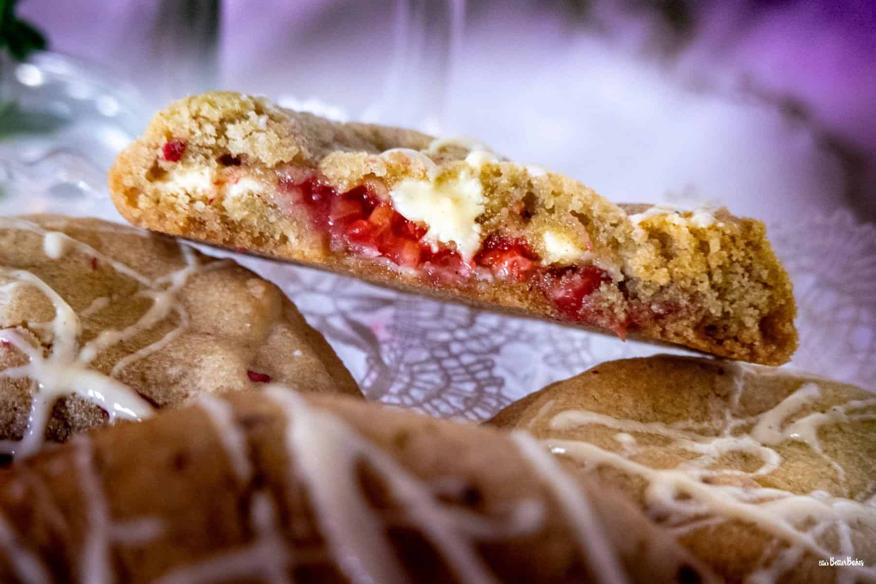 close up of a cut raspberry and white chocolate cookies cut