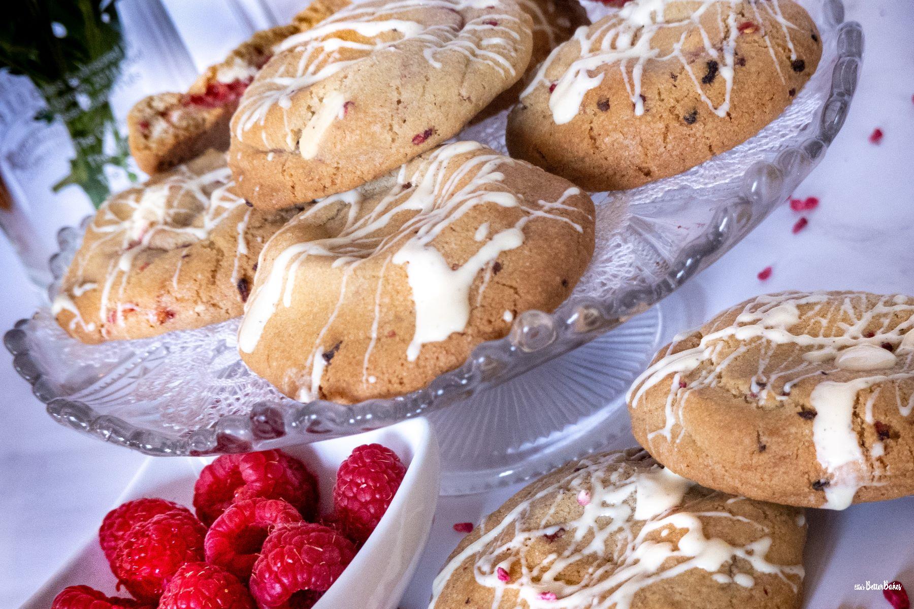 raspberry and white chocolate cookies on a cake stand
