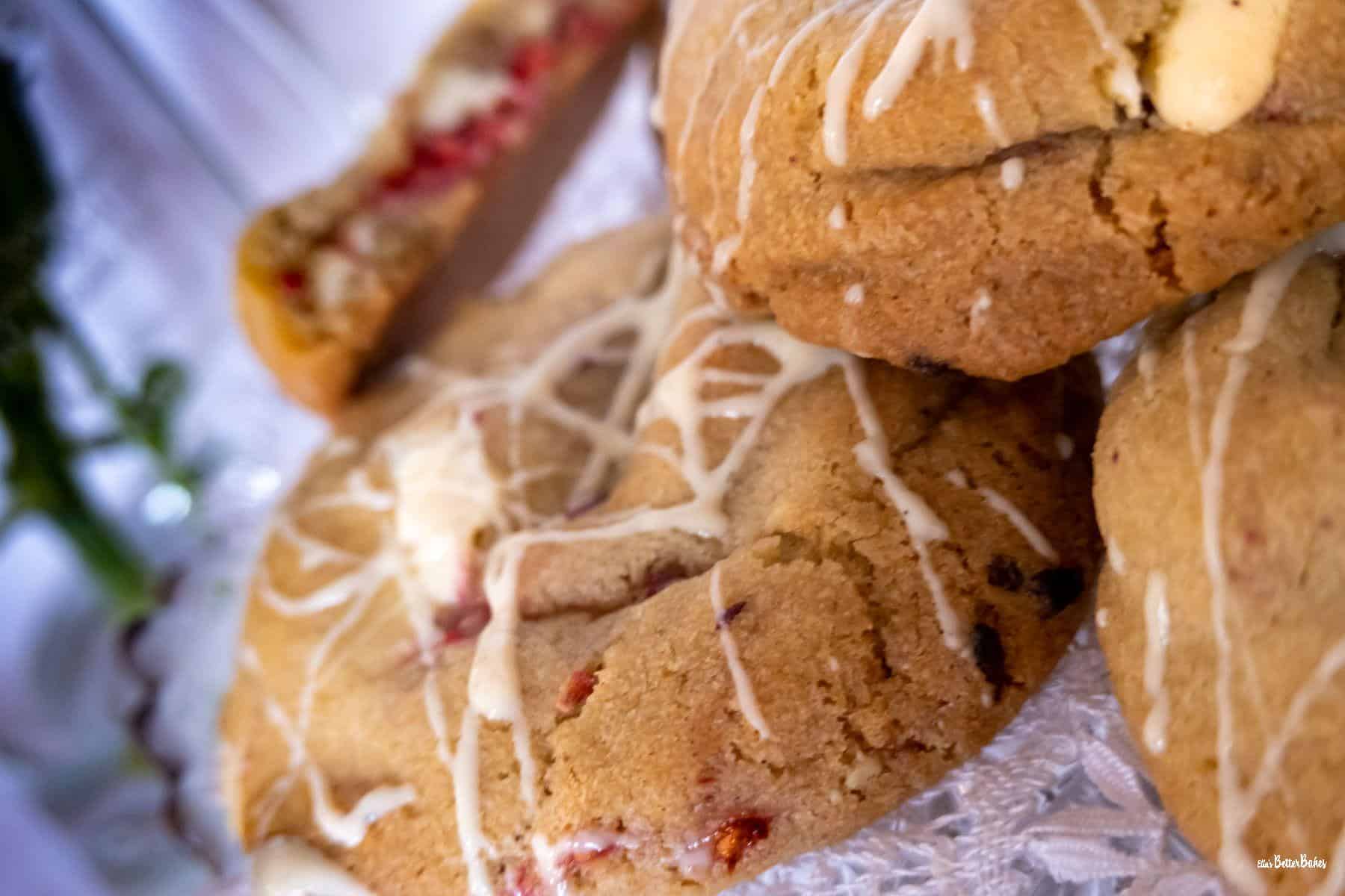 close up of raspberry and white chocolate cookies on cake stand