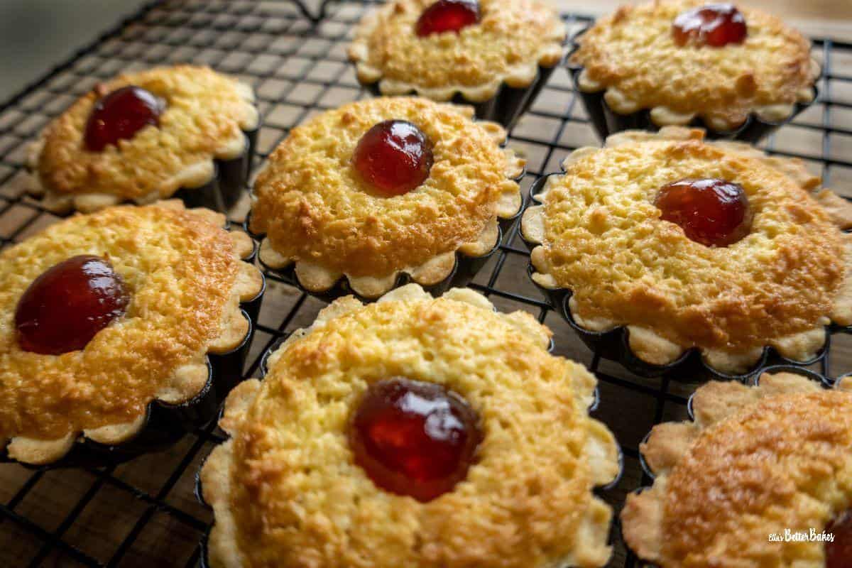 baked coconut tarts on cooling rack