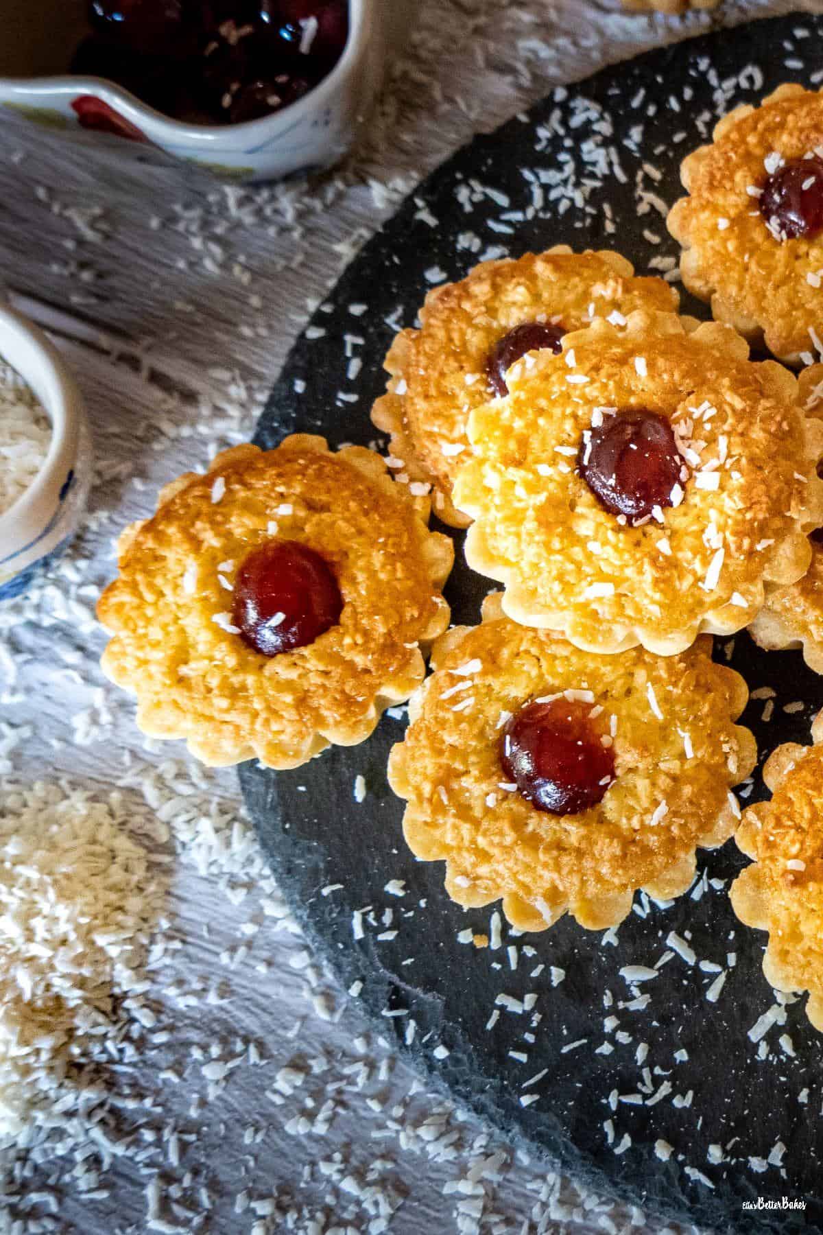 portrait picture coconut tarts to right on slate