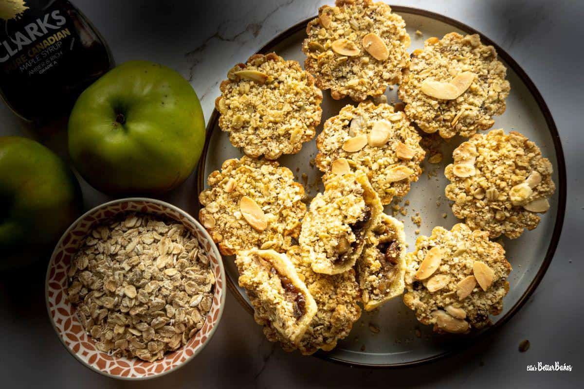 plate of apple crumble tartlets next to ingredients