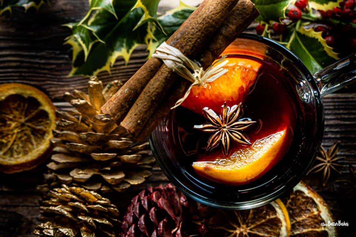 glass of mulled wine surrounded by decorations
