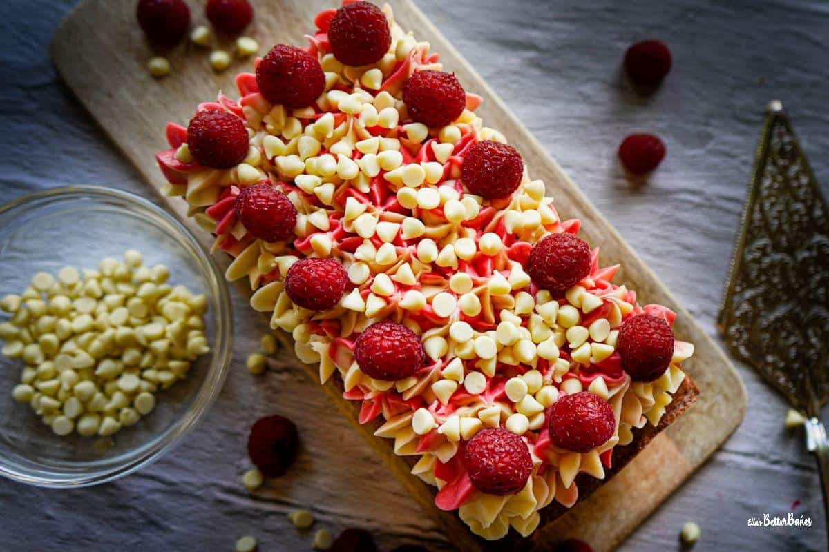 raspberry and white chocolate cake on a board
