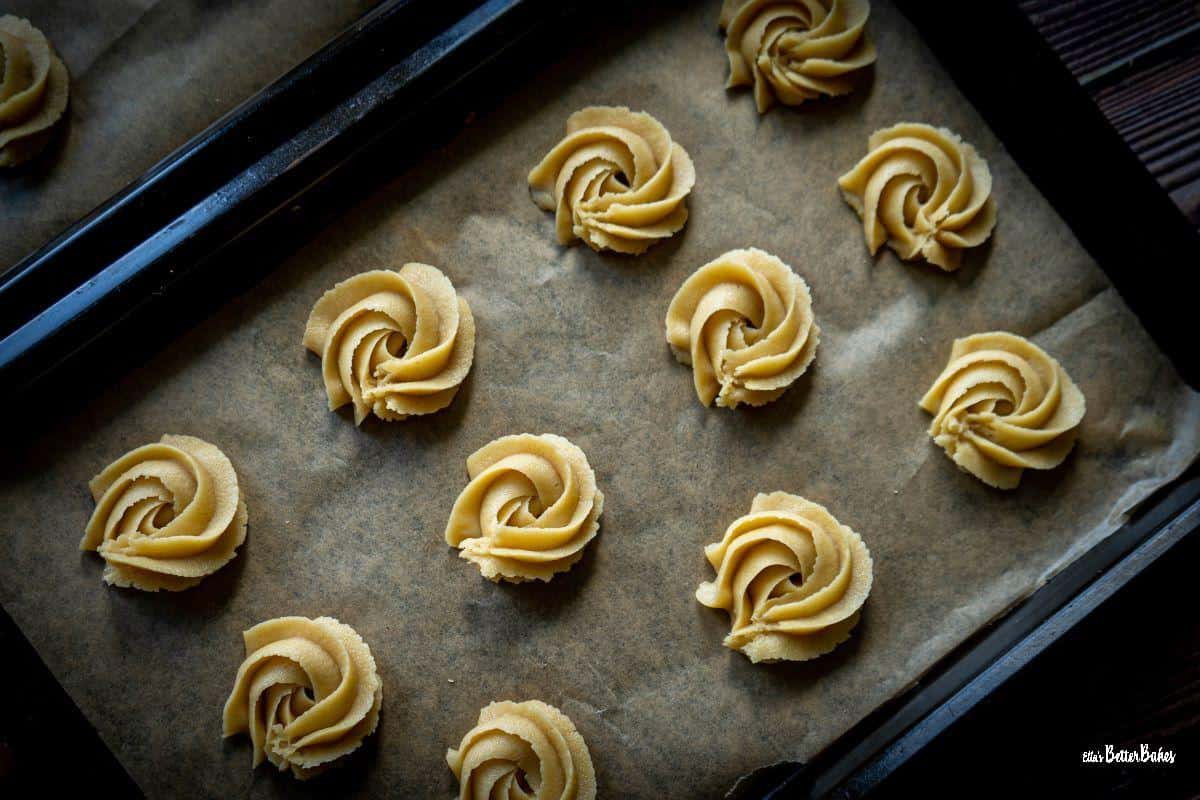 Piped biscoff butter biscuits on baking tray
