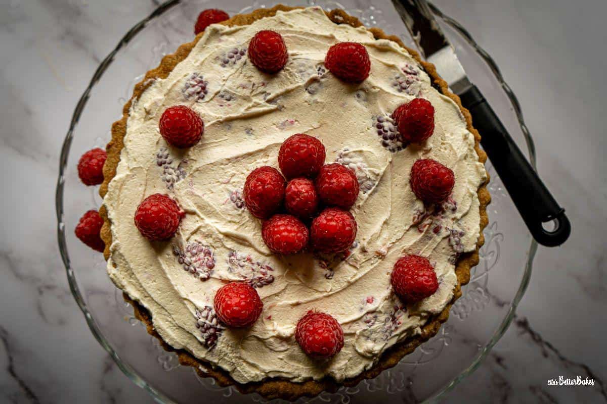 cream and raspberries added to chocolate raspberry tart