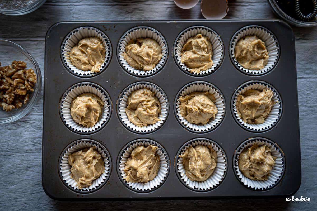 coffee and walnut cake batter added to muffin cases