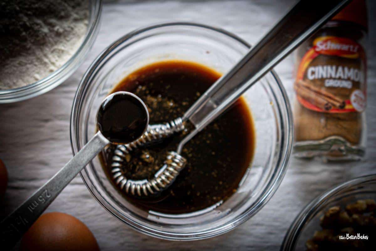 vanilla bean paste being added to coffee syrup