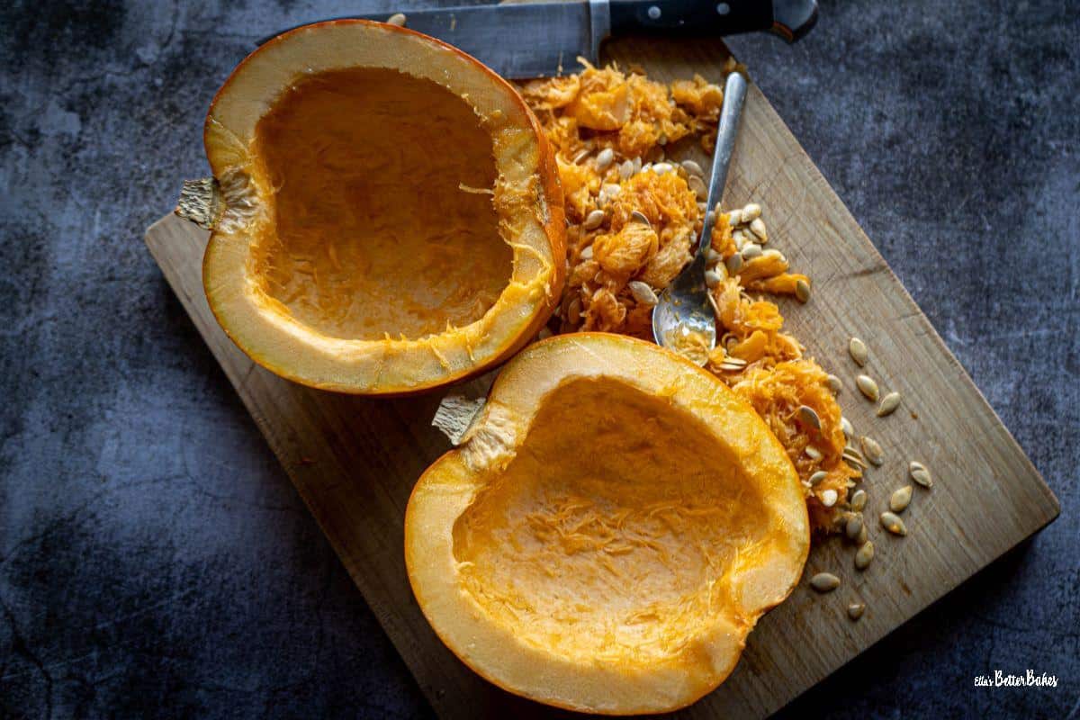 pumpkin cut in half and contents scraped out