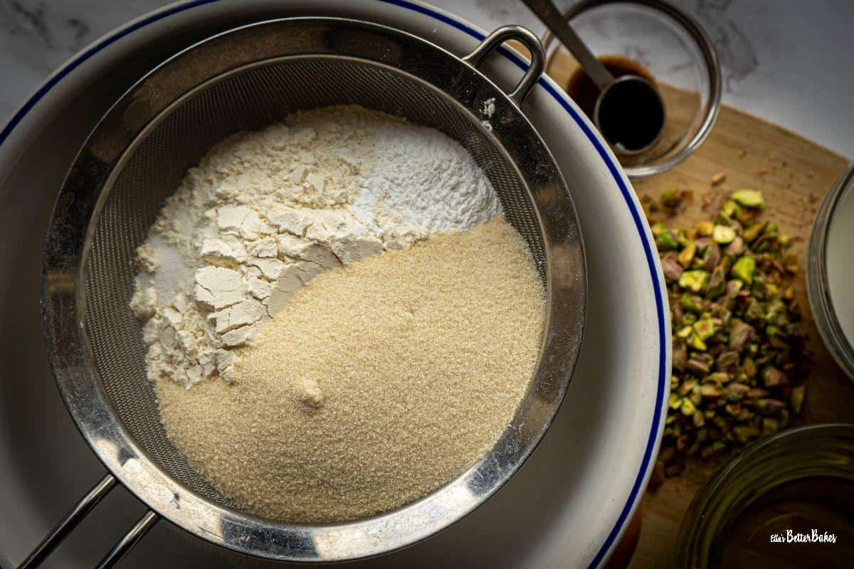 flour, salt, baking powder and sugar in sieve over a bowl