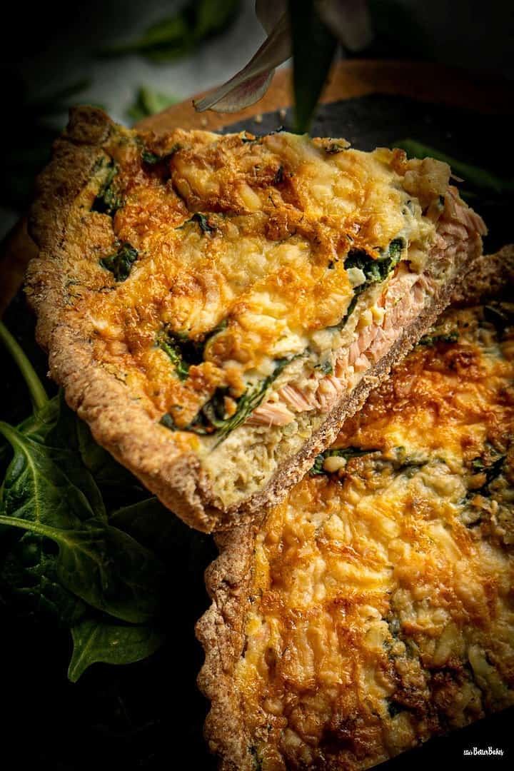 portrait size of several slices of salmon and spinach quiche