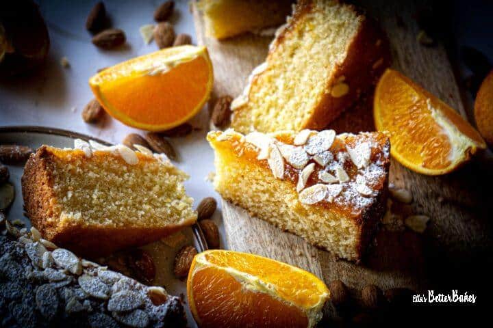 slices of italian almond cake next to almonds and sliced oranges
