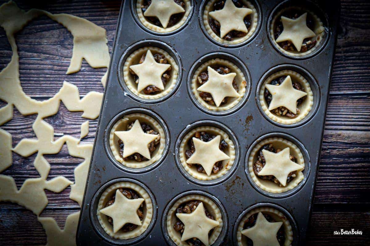 mince pies added to a muffin tin ready to bake