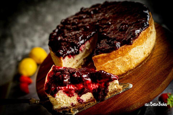 slice of vanilla cheesecake with fruit topping cut