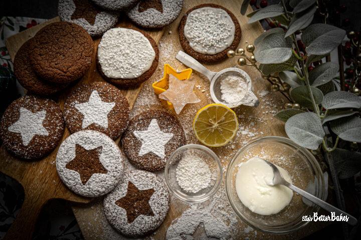 spicy christmas cookies laid out for decorating next to icing