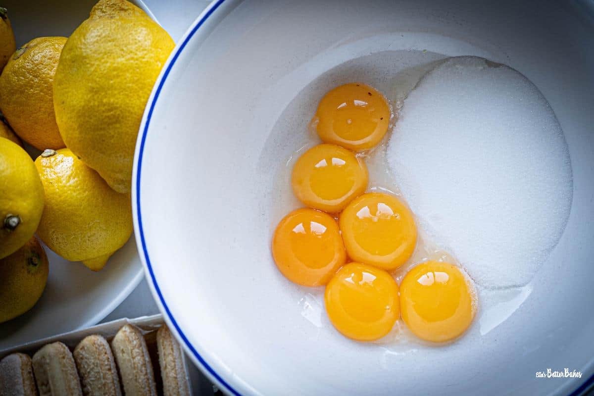 egg yolks and sugar in a bowl ready to be whisked together for italian custard