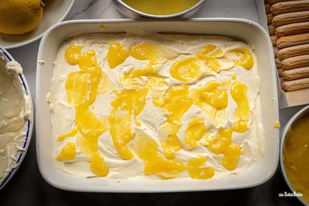 layer of mascarpone cream spread out over the sponge finger, covered in a layer of lemon curd