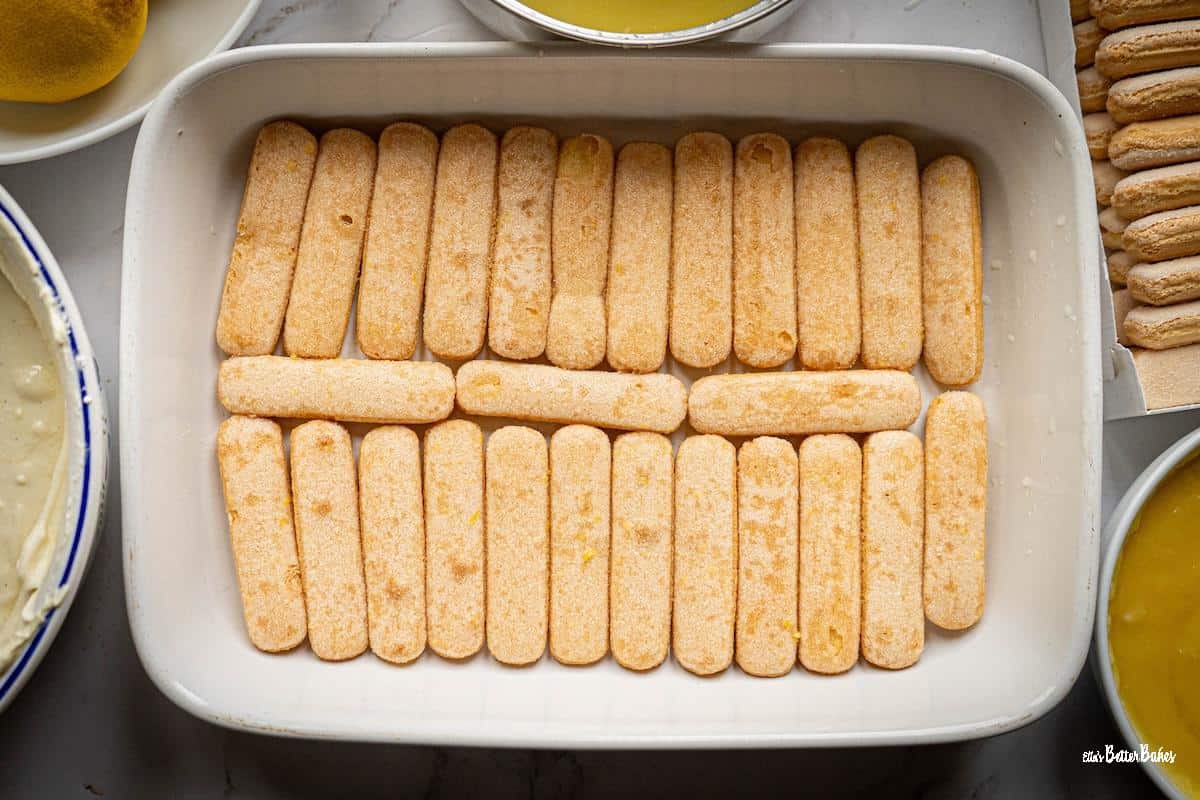 sponge fingers soaked in lemon syrup and arranged in a layer in a serving dish
