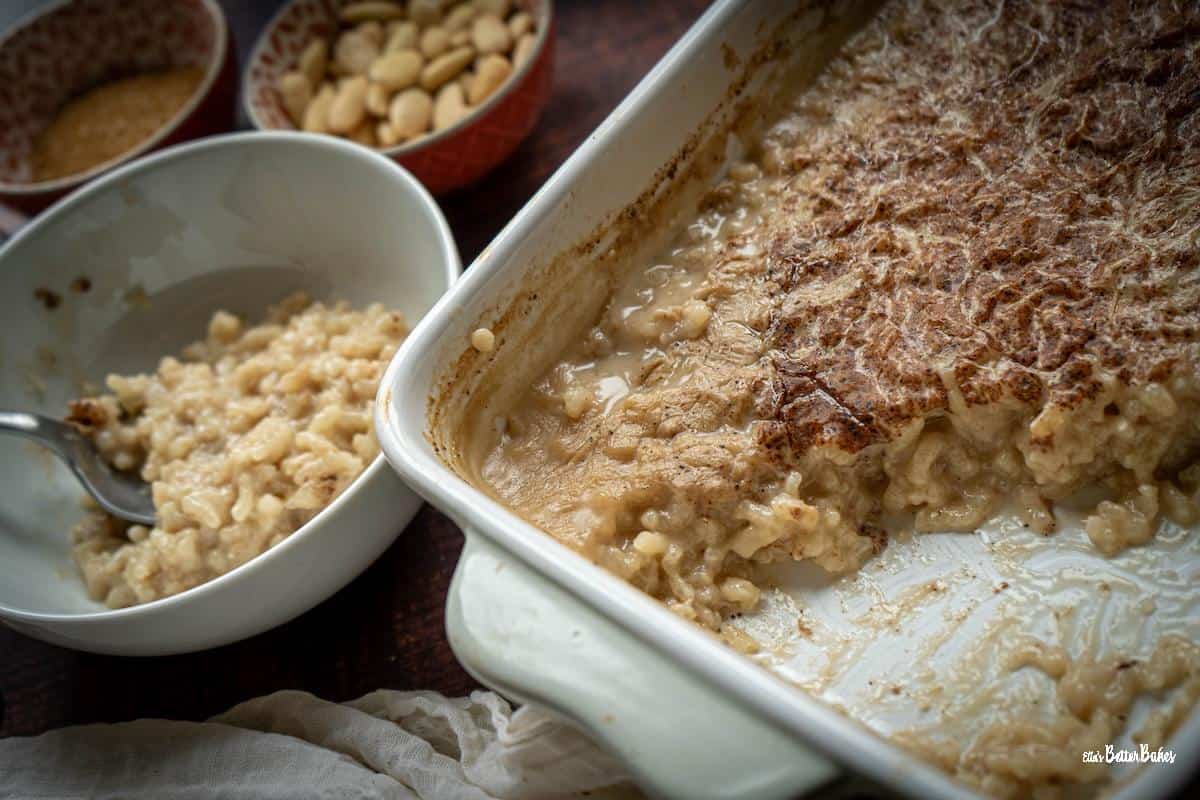 almond milk rice pudding in bowl next to serving dish
