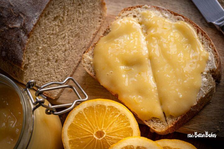 easy homemade lemon curd on piece of bread next to lemons