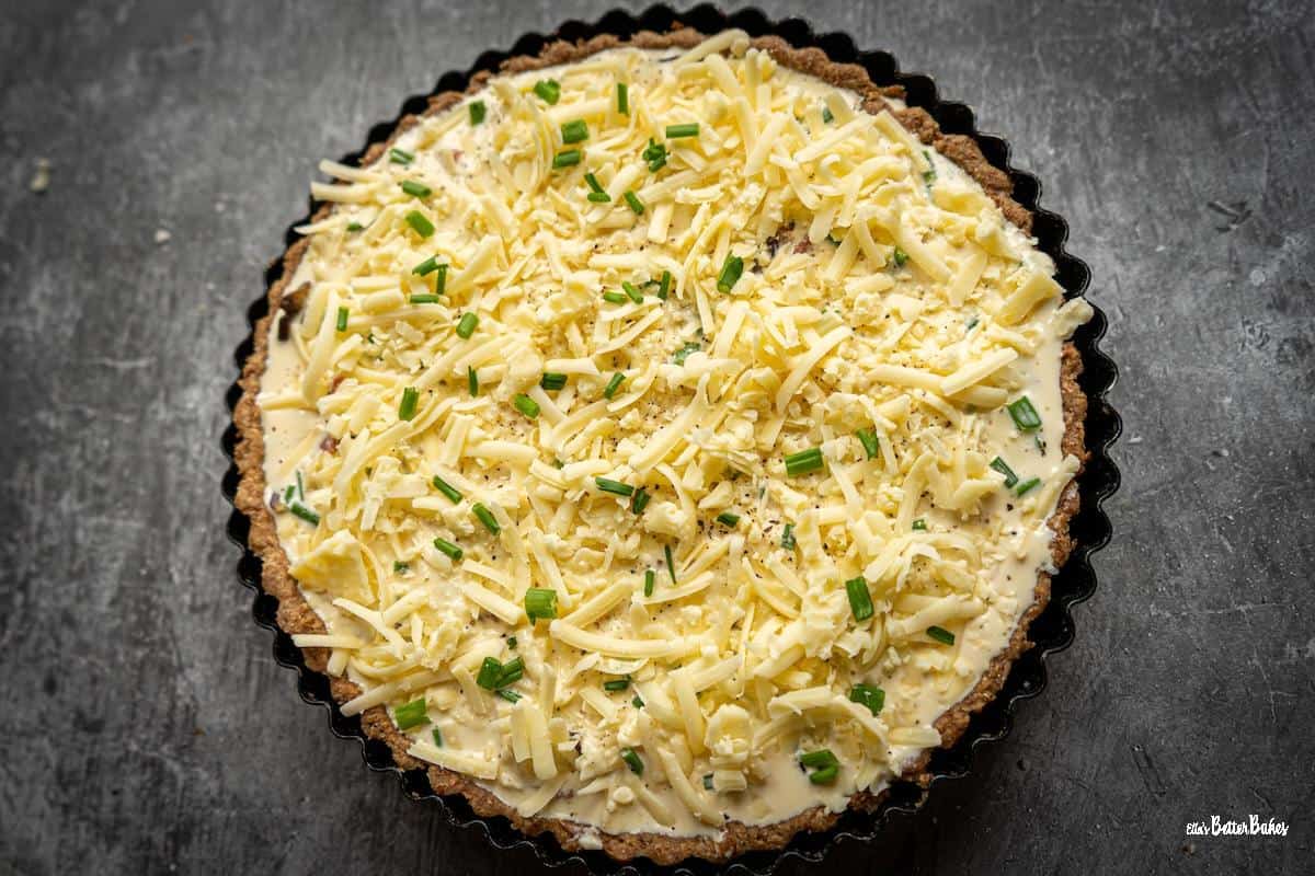 quiche filled with all ingredients ready to bake