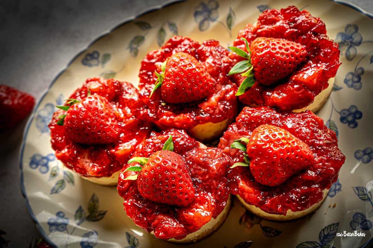 five mini roasted strawverry cheesecakes on a plat