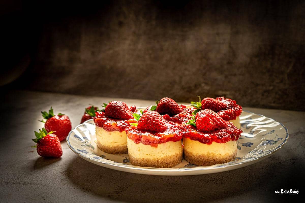five strawberry cheesecakes on a plate