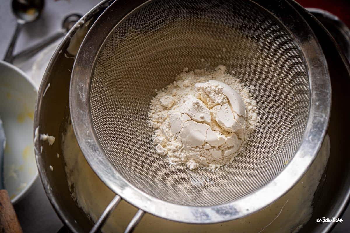 flour sifted into cheesecake mixture