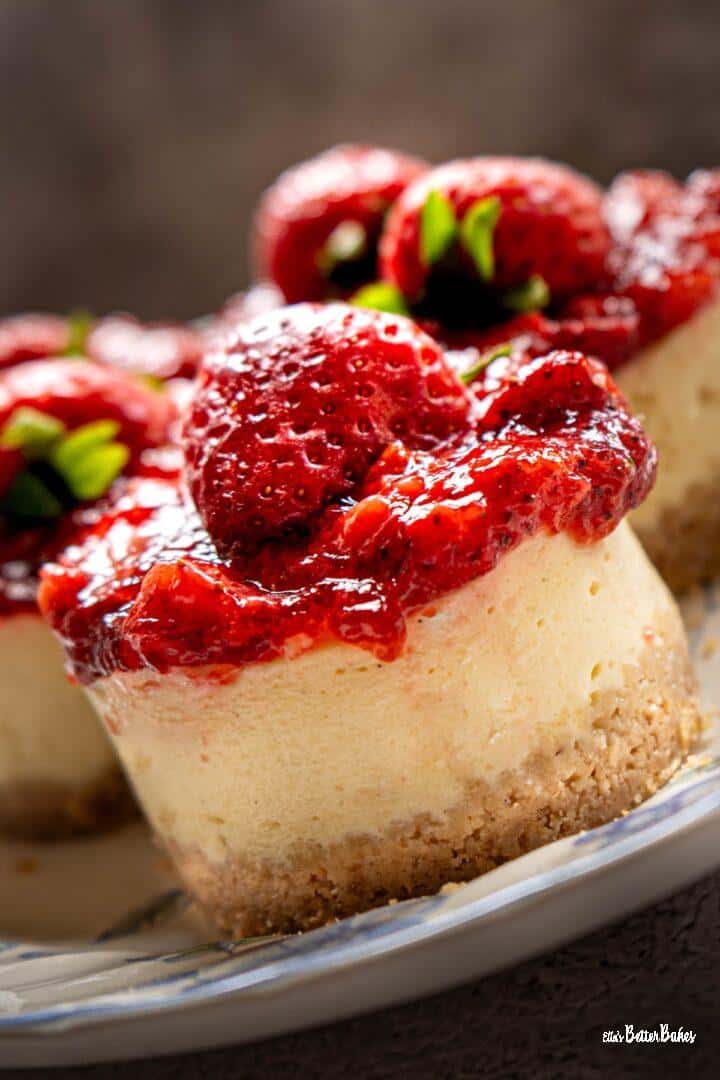 portrait size of close up of strawberry cheesecake on a slant