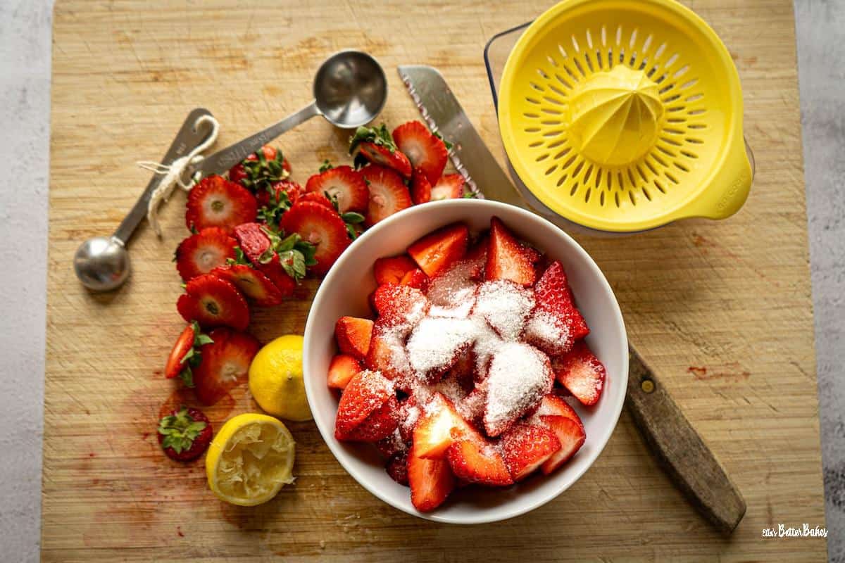 strawberries cut up in a bowl with sugar on top